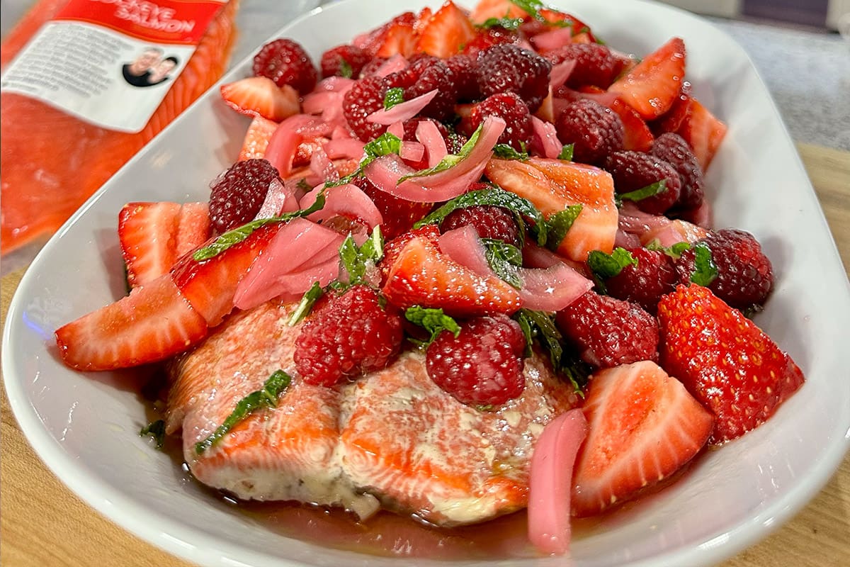 Whole grilled sockeye salmon fillet, topped with fresh strawberries, raspberries, sweet and sour red onions, and fresh mint.