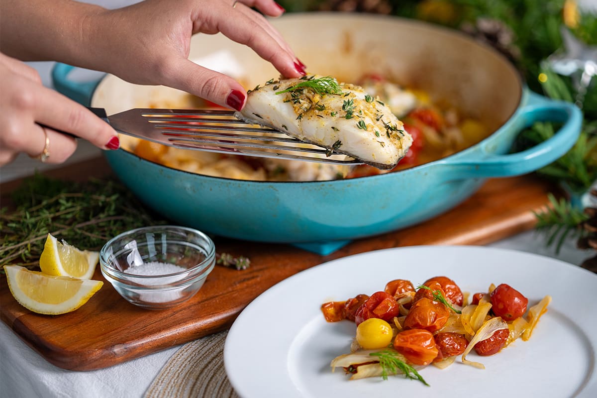 Seasoned lingcod fillets baked with cherry tomatoes and fennel.